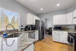 Fully equipped kitchen with stainless steel appliances, granite counter tops